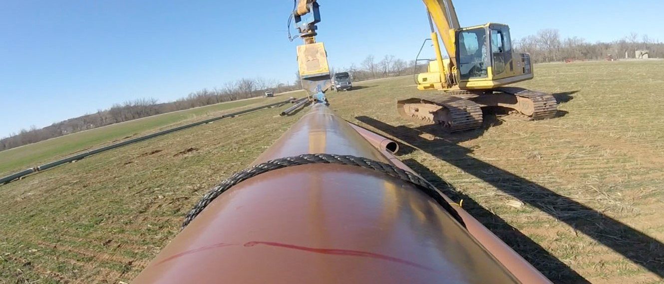 Crew and equipment working a pipeline right-of-way
